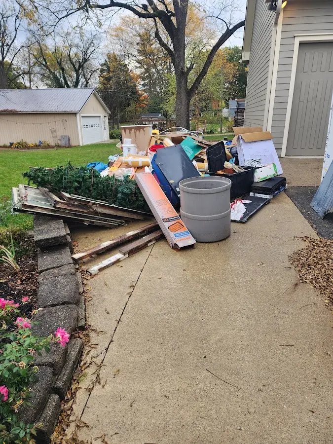 Dumpster being loaded with debris for Roofing Dumpster Rental in Atwater